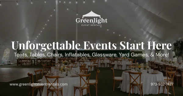 Interior of a large white event tent set up with round tables, wooden chairs, and string lights.