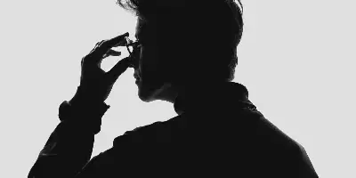 Black-and-white silhouette portrait of a person in profile adjusting glasses against a light background.