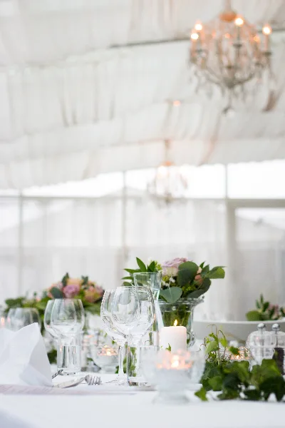 Elegant wedding banquet table setting with floral arrangements and chandeliers