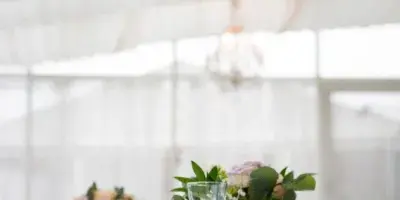 Elegant wedding banquet table setting with floral arrangements and chandeliers