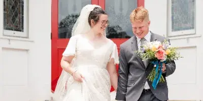 Bride and Groom walking down the steps of the exit of a Mississippi Church in Starkville, MS