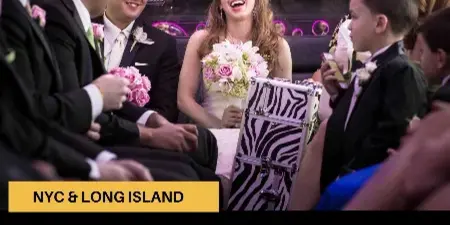 A bride and wedding party seated inside a party bus with colorful lighting.