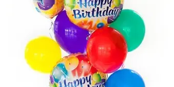 A colorful balloon bouquet featuring 'Happy Birthday' printed balloons and solid-colored latex balloons.