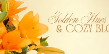 A close-up photograph of a fresh flower arrangement featuring vibrant orange lilies and green buds.