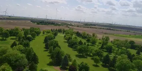 Aerial view of the Benton County Golf Course fairways and trees in Fowler, Indiana.