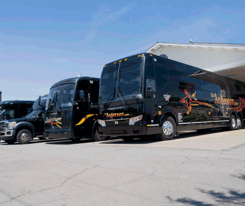 A fleet of black Anderson Coach & Travel charter buses parked in a lot.