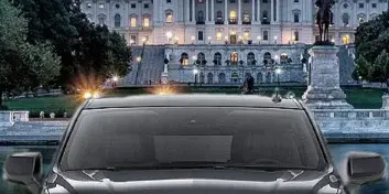 A black luxury SUV parked in front of the US Capitol building with text overlay reading 'Chauffeured Transportation At Its Best!'