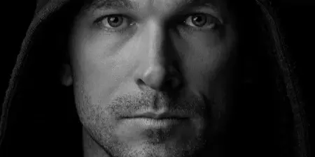Black-and-white portrait of a man wearing a hood, shown as a sample of Steele House Photography’s work.