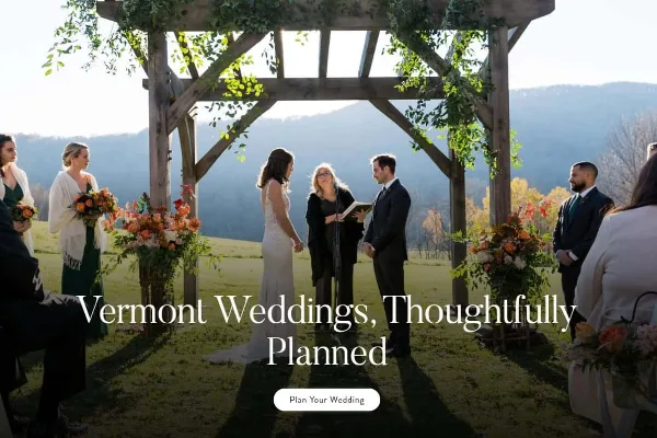 Outdoor wedding ceremony under a wooden pergola with mountains in the background