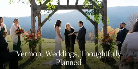 Outdoor wedding ceremony under a wooden pergola with mountains in the background