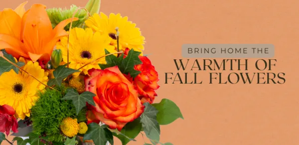 A close-up of a colorful floral arrangement with orange lilies, yellow daisies, and red roses.