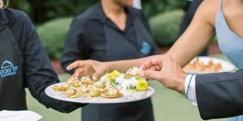 Rocky Top Catering staff serving appetizers to guests at an outdoor event