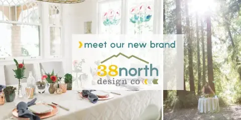 A professionally styled event table with floral centerpieces and a white tablecloth in a bright room, with a '38north design co' logo overlay.