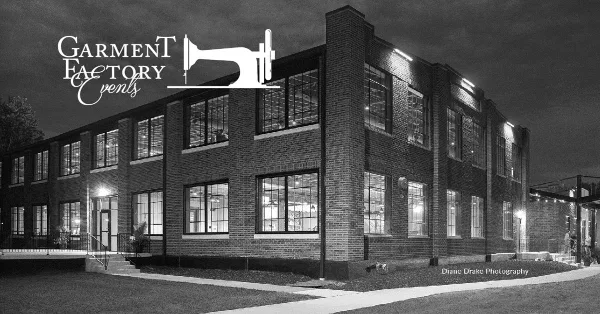 Exterior view of a large, historic brick building with multiple windows, illuminated at night, identified as the Garment Factory Events venue.