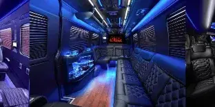 Interior of a luxury limousine or shuttle van featuring leather seating, ambient blue lighting, and a bar area.