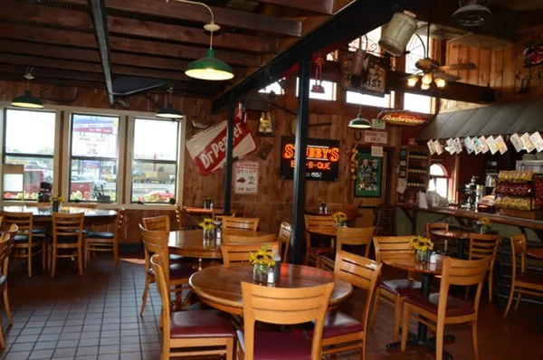 Interior view of the Stubby's BBQ restaurant dining room with wooden tables and chairs.