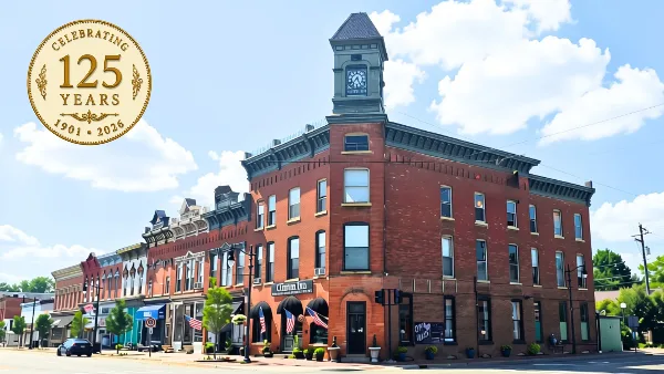Exterior view of the historic Clinton Inn building featuring a prominent clock tower and brick facade.
