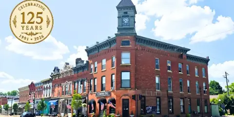 Exterior view of the historic Clinton Inn building featuring a prominent clock tower and brick facade.