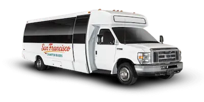 A white shuttle bus with San Francisco Charter Buses branding parked on a black background.