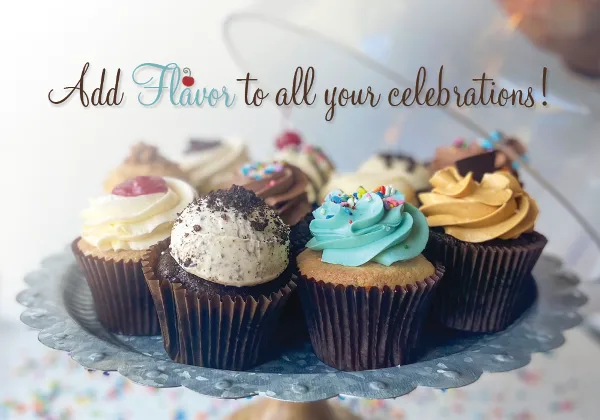 Assorted frosted cupcakes with sprinkles and toppings arranged on a decorative cake stand.