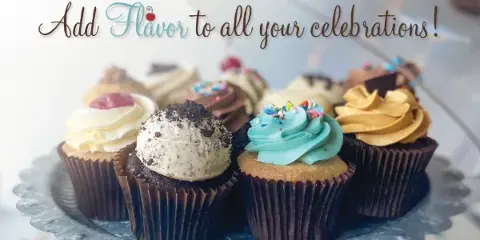 Assorted frosted cupcakes with sprinkles and toppings arranged on a decorative cake stand.