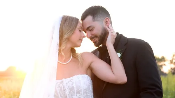 A bride and groom sharing an intimate moment outdoors during golden hour.