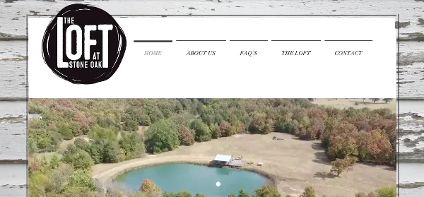 Aerial view of The Loft at Stone Oak venue grounds with a pond, open field, and surrounding trees.