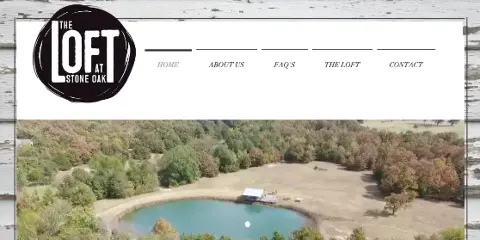 Aerial view of The Loft at Stone Oak venue grounds with a pond, open field, and surrounding trees.