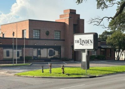 Exterior view of The Linden venue building with its sign visible in the foreground.