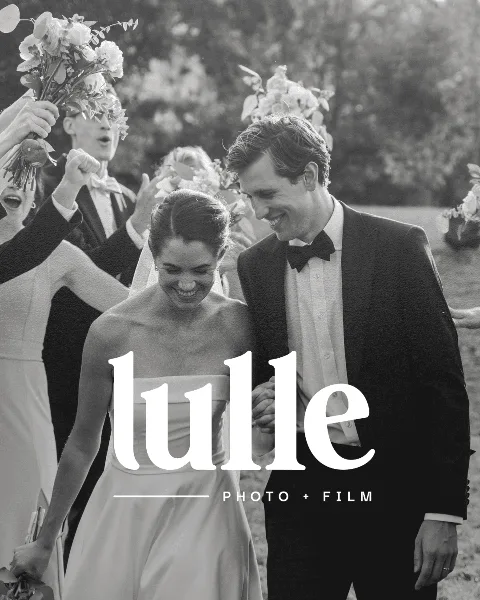 Black and white wedding photograph of a bride and groom smiling, with the Lulle Photo + Film logo overlaid.