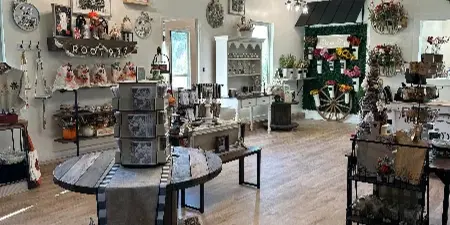 Interior view of the Root 937 store featuring rustic decor, wooden signs, and home goods on display.