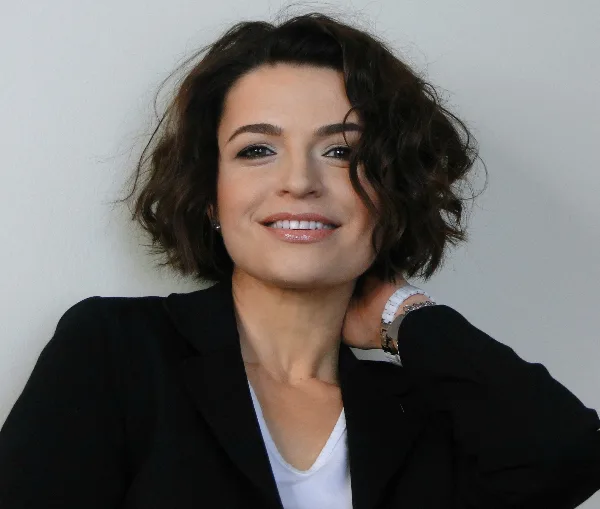Portrait of Tatyana Wilcox, a makeup artist, smiling at the camera.