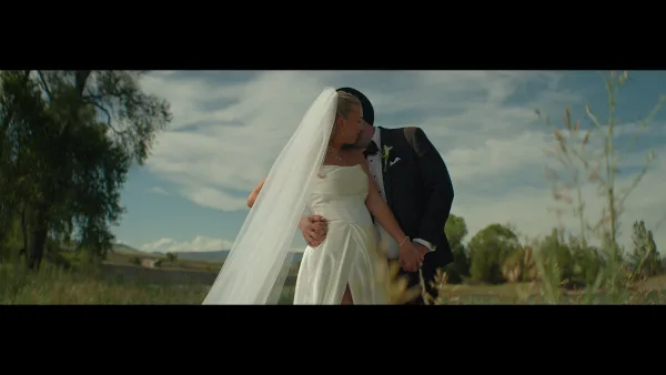 A bride and groom sharing a romantic moment in a Montana field, captured in a cinematic wedding photography style.