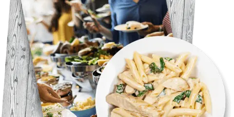 Guests serving themselves from a buffet of plated meals and side dishes at a catering event.