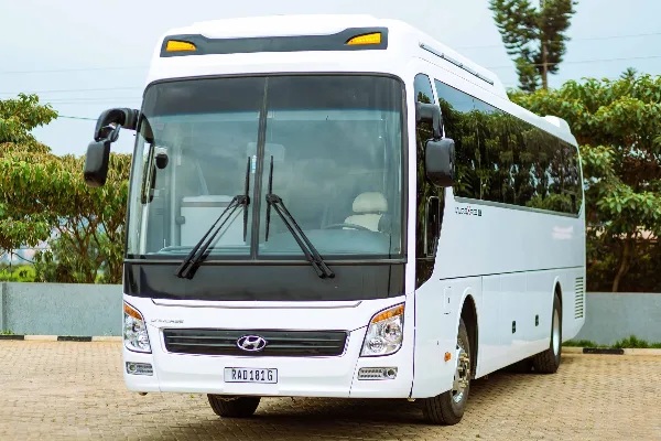 A white Hyundai Universe charter motor coach parked on a paved surface.