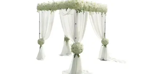 A white wedding arch structure draped with white fabric and decorated with floral arrangements.