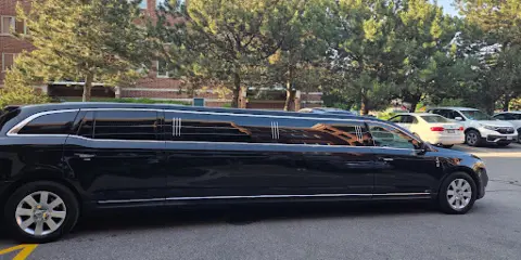 A black stretch limousine parked in a parking lot.