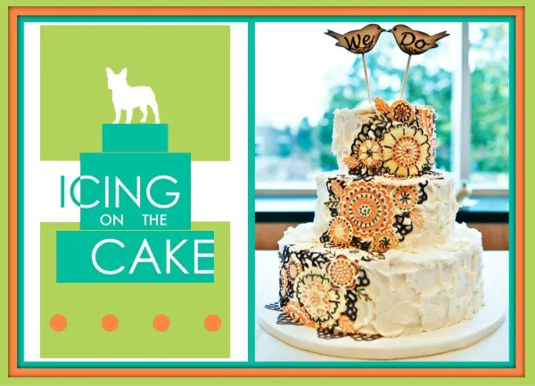 A three-tiered white wedding cake decorated with orange and black floral patterns and topped with a 'We Do' bird topper.