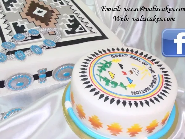 A white cake decorated with Native American geometric patterns and edible blue and silver jewelry designs.