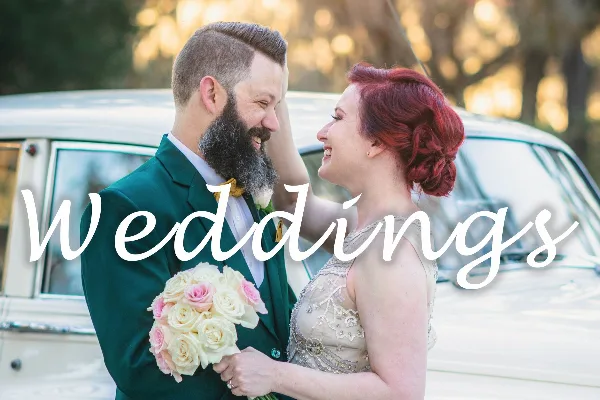 A smiling bride and groom in formal attire standing together with a bouquet, with the word 'Weddings' overlaid in script.