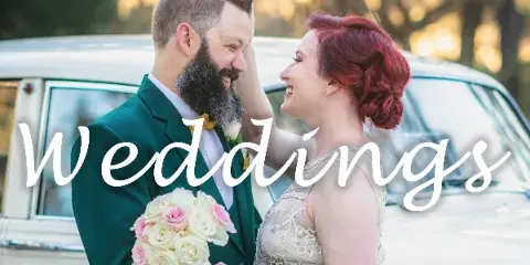 A smiling bride and groom in formal attire standing together with a bouquet, with the word 'Weddings' overlaid in script.