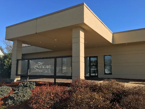 Exterior view of the Tuscany Special Events Center building with signage on the window.