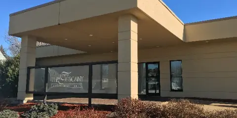 Exterior view of the Tuscany Special Events Center building with signage on the window.