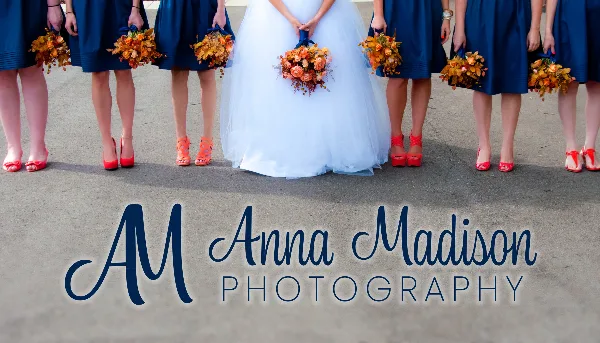 Bride in a white gown and bridesmaids in blue dresses holding orange bouquets, with Anna Madison Photography logo overlaid.