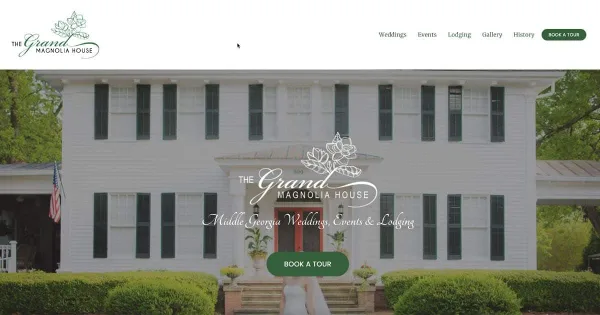 Exterior view of a white two-story historic antebellum house with dark shutters, a front veranda, manicured hedges, and a bride standing on the steps.
