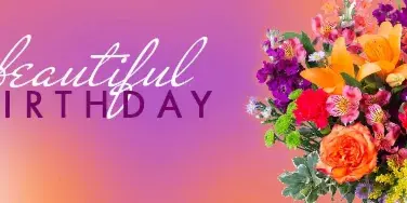 A colorful floral arrangement featuring orange roses, lilies, and purple flowers against a pink and orange gradient background.