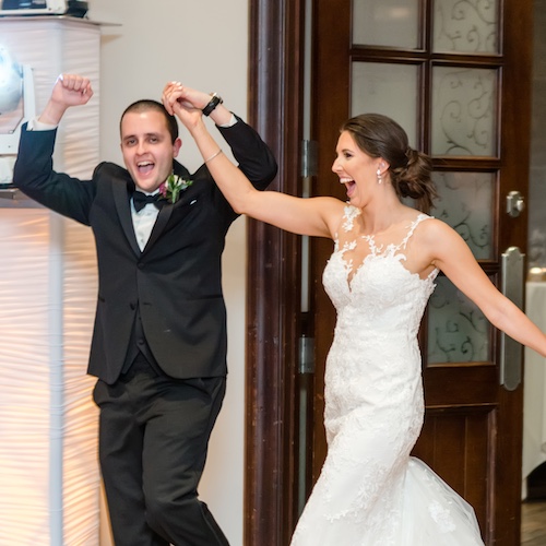 A bride and groom dancing at a wedding reception.