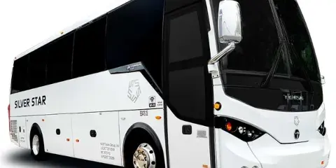 A white Silver Star 34-passenger coach bus parked on a white background.