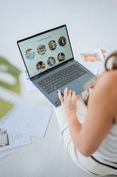 A person browsing the Elevated Events and Rentals website on a laptop, displaying various event rental categories and planning services.