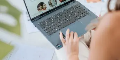 A person browsing the Elevated Events and Rentals website on a laptop, displaying various event rental categories and planning services.